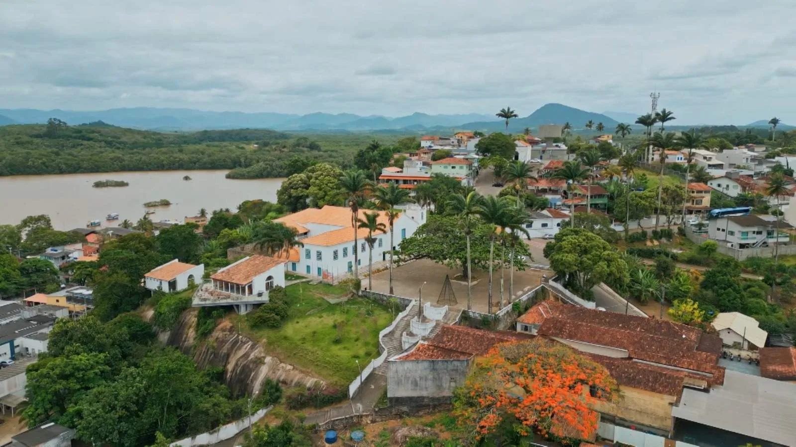 Vista aérea do Santuário Nacional de São José de Anchieta em Anchieta, Espírito Santo, mostrando a edificação histórica à margem do Rio Benevente